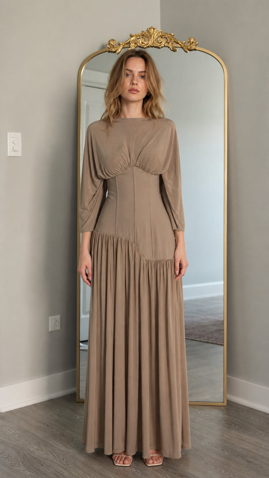 Front view of model wearing taupe long-sleeve maxi dress with corset waist