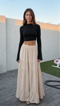 Front view of model wearing beige high-waisted tiered maxi skirt