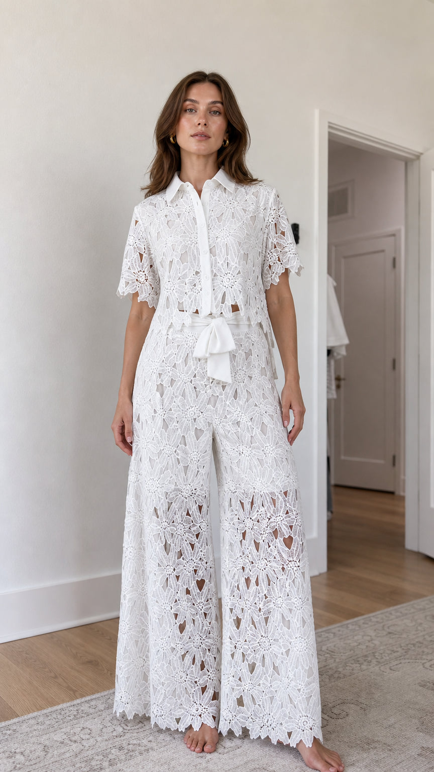Front view of woman wearing white floral lace shirt and wide-leg pants set