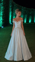 Front view of light blue off-shoulder ball gown in garden setting