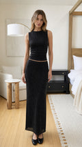 Front view of model wearing black sleeveless sparkle knit top and maxi skirt set