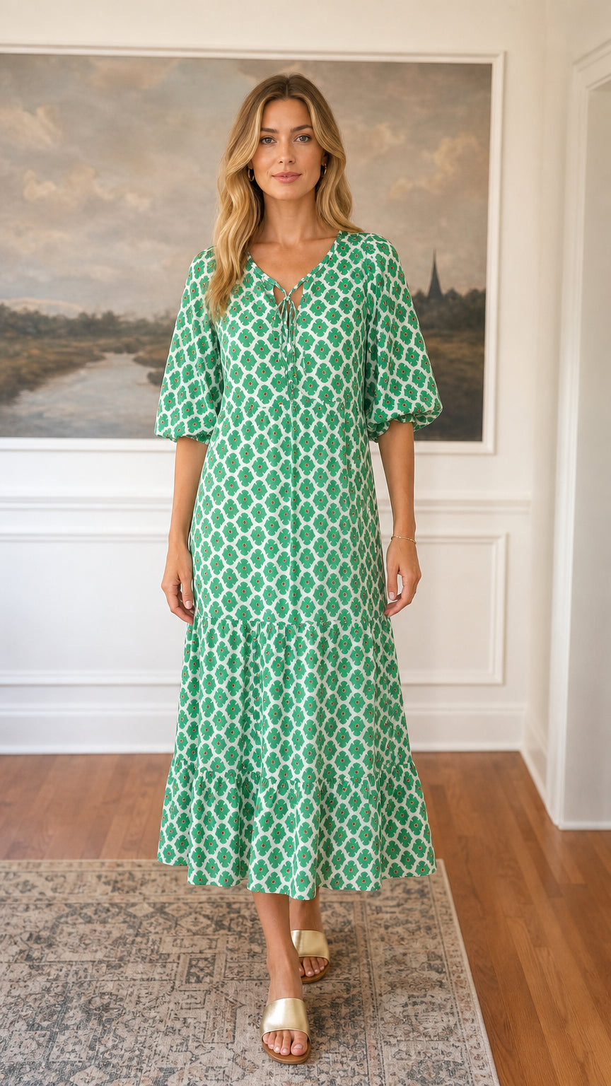 Front view of green floral tiered midi dress