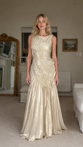 Front view of model wearing champagne ruched maxi dress