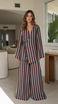 Model wearing brown striped wrap top and wide-leg pants set front view