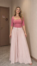 Front view of woman wearing pink matching scoop neck top and wide leg pants set