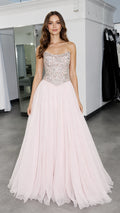 Front view of model wearing pink embellished strapless formal gown