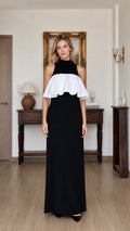 Front view of model wearing black and white mock neck ruffle maxi dress