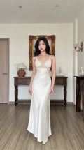 Front view of woman wearing white satin maxi slip dress with crochet contrast