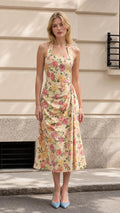 Front view of model wearing yellow floral halter midi dress