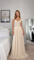 Front view of model wearing champagne lace bodice evening dress