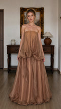 Front view of model wearing brown strapless tiered maxi dress