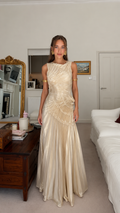 Front view of champagne ruched sleeveless mermaid maxi gown