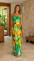Front view of tropical green printed backless maxi dress with side fringe detail