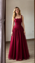 Front view of burgundy corset-style long tulle evening gown