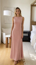 Front view of woman wearing pink sleeveless maxi dress