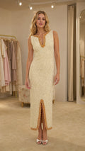 Front view of woman wearing cream beaded V-neck midi dress