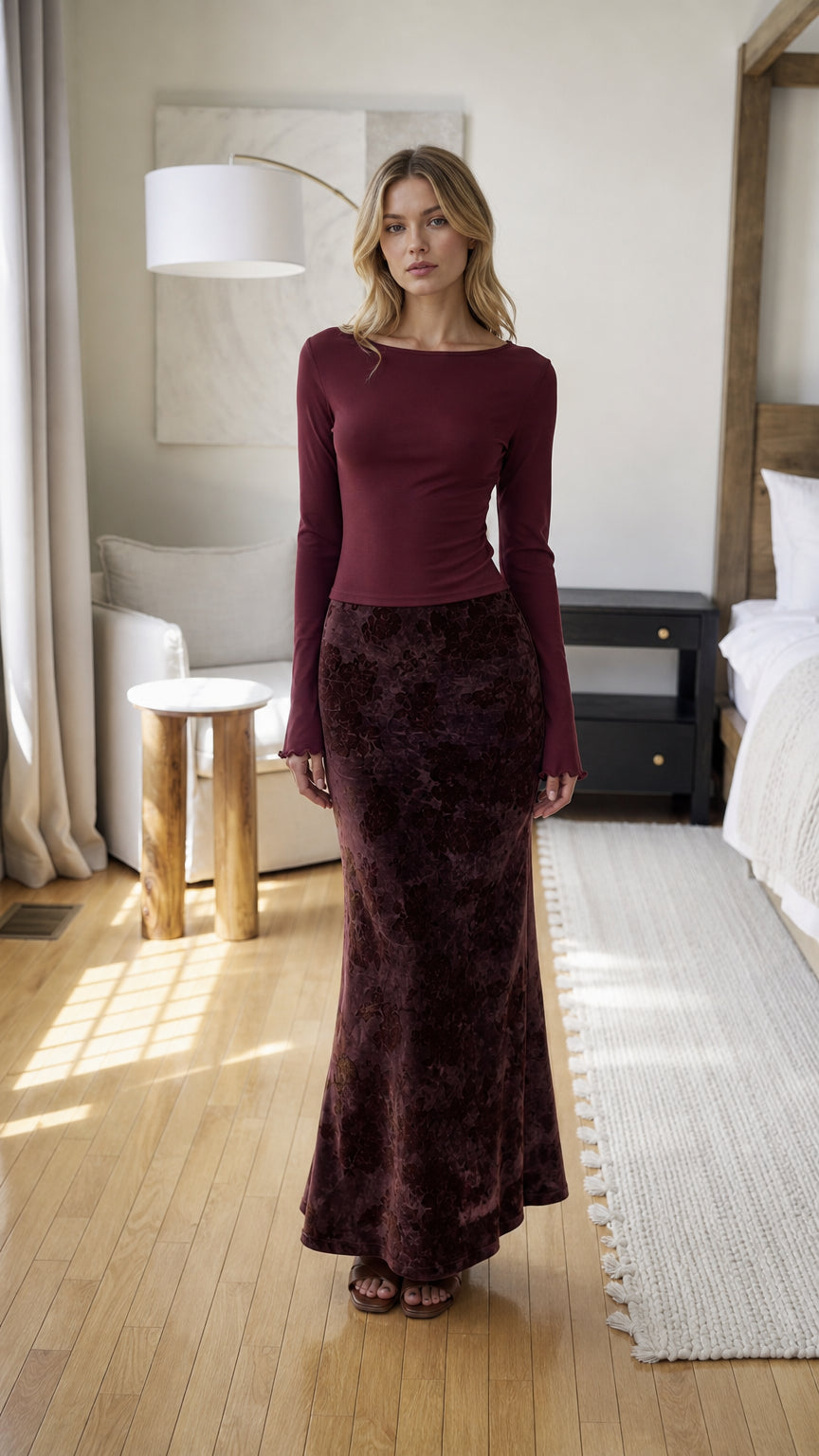 Front view of burgundy long sleeve top and velvet floral maxi skirt set