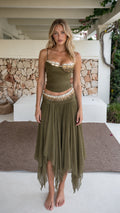 Front view of model wearing olive green beaded two-piece crop top and asymmetric skirt set
