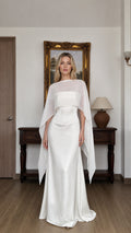 Front view of woman wearing white cape overlay evening dress