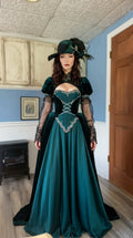 Front view of Victorian Gothic emerald green velvet ball gown with feathered hat
