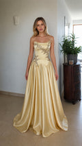 Front view of champagne strapless beaded corset evening dress