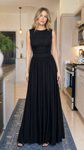 Model wearing black sleeveless ruched maxi dress front view