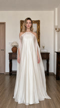 Front view of model wearing ivory halter neck flowy maxi dress