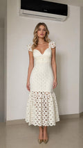 Front view of woman wearing white lace mermaid midi dress