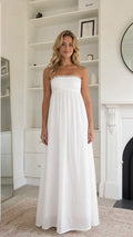 Front view of woman wearing white strapless lace trim maxi dress