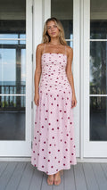 Front view of model wearing pink polka dot smocked maxi dress