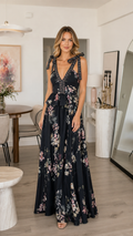 Front view of black floral tie shoulder deep V maxi dress with tiered waist detail
