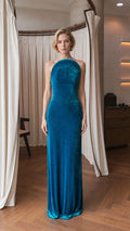 Front view of model wearing teal velvet halter evening gown