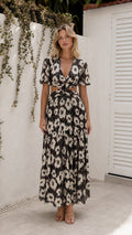 Front view of model wearing black floral cutout maxi dress