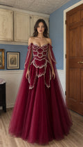 Front view of burgundy off-shoulder beaded tulle evening gown