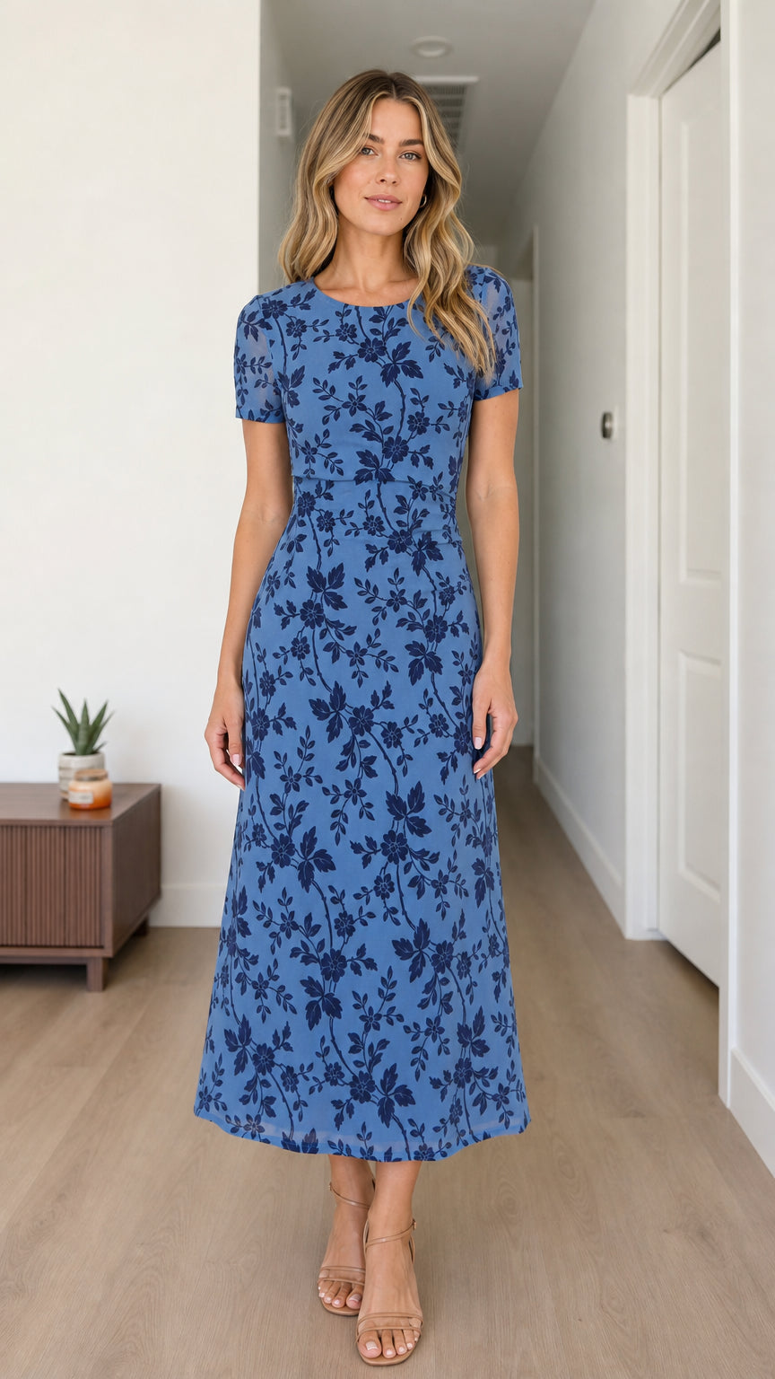 Front view of woman wearing blue floral midi dress