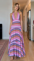 Model wearing pink multi wave pattern halter maxi dress front view