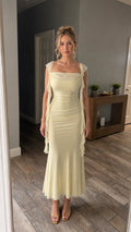 Front view of model wearing the yellow ruffled cowl neck maxi dress