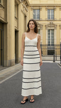 Front view of woman wearing white striped knit cami maxi dress