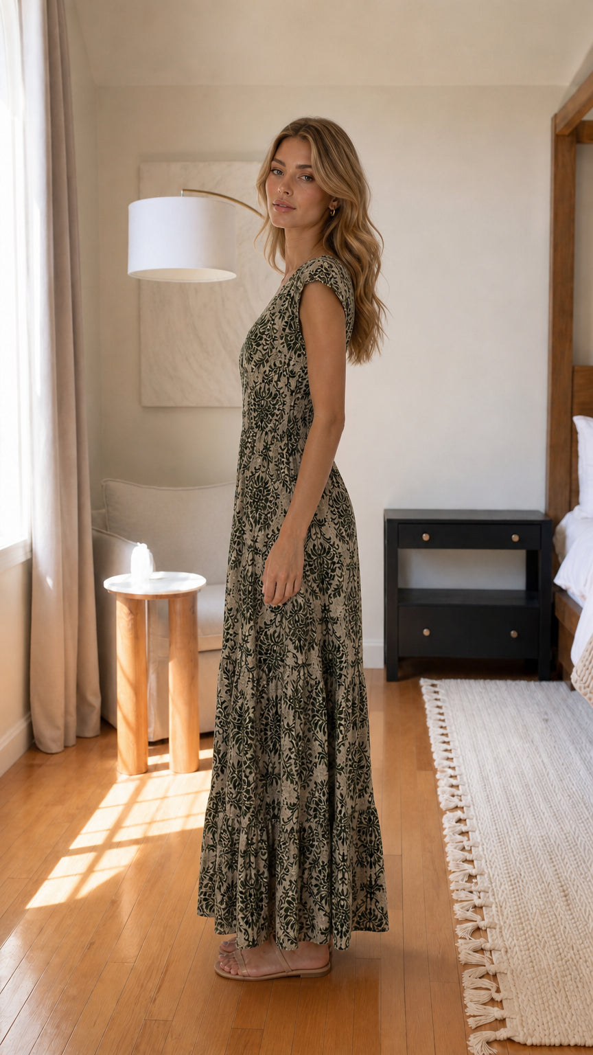 Side profile of model in sage green maxi dress