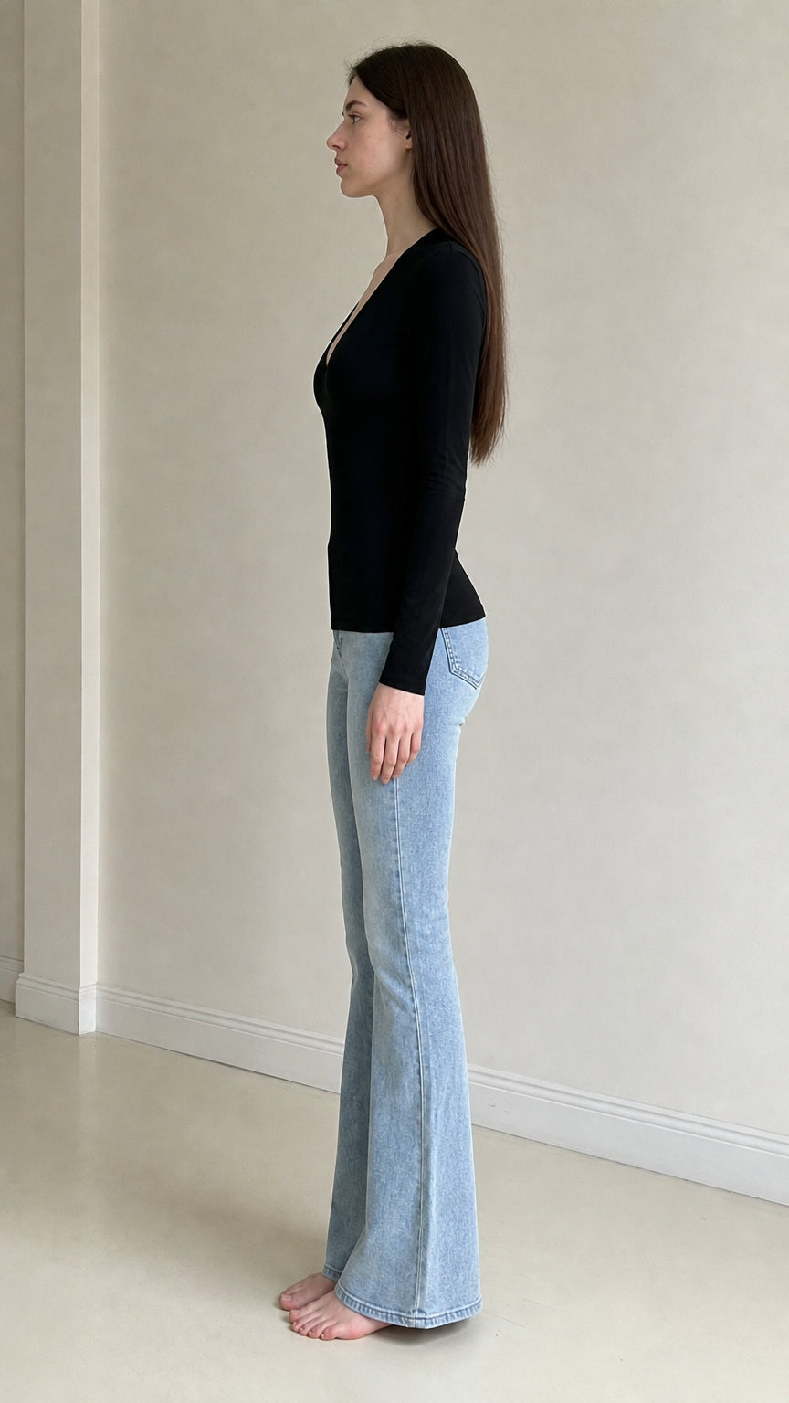 Side profile view of woman wearing black long sleeve top