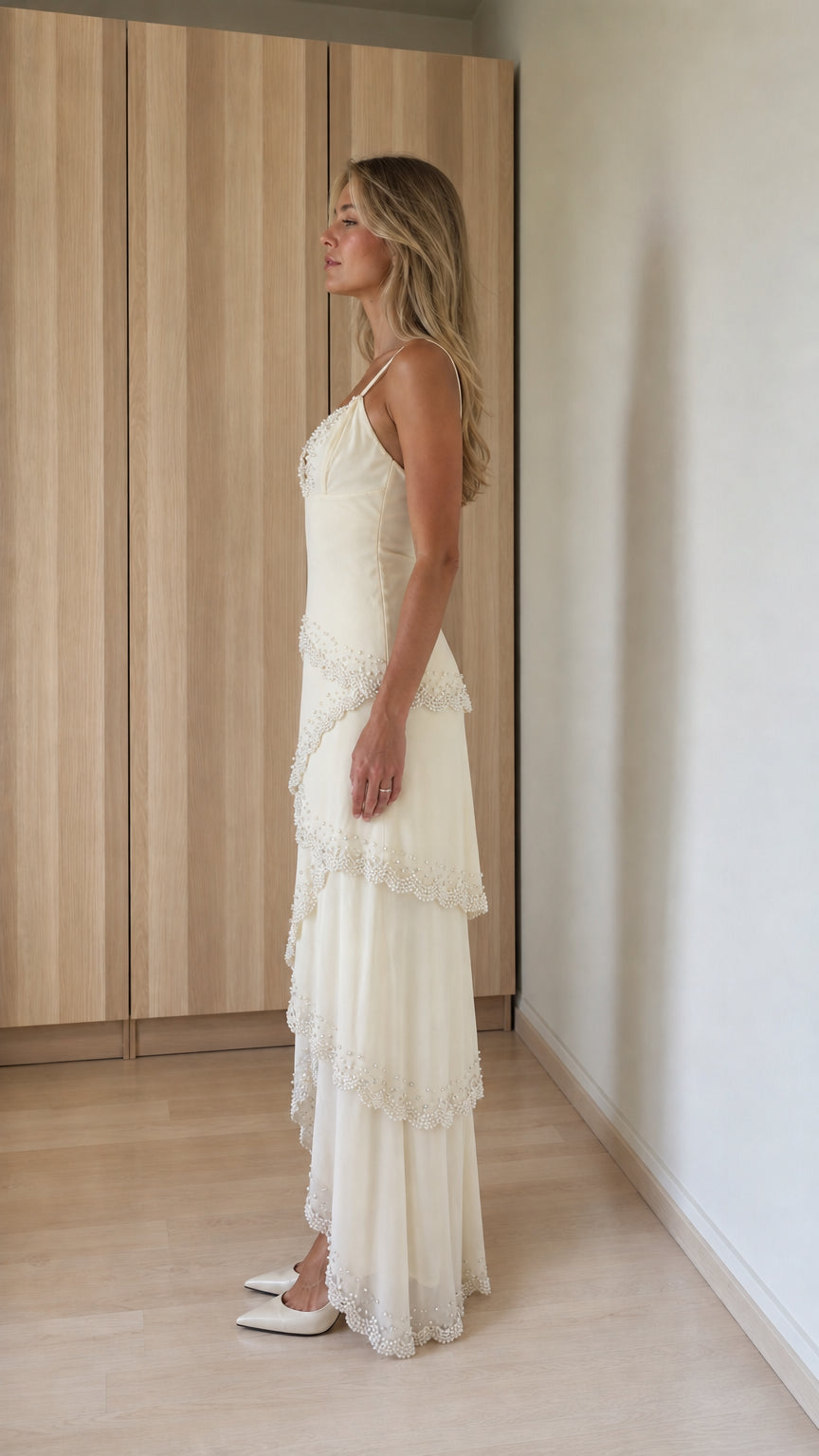 Side profile of ivory tiered maxi dress