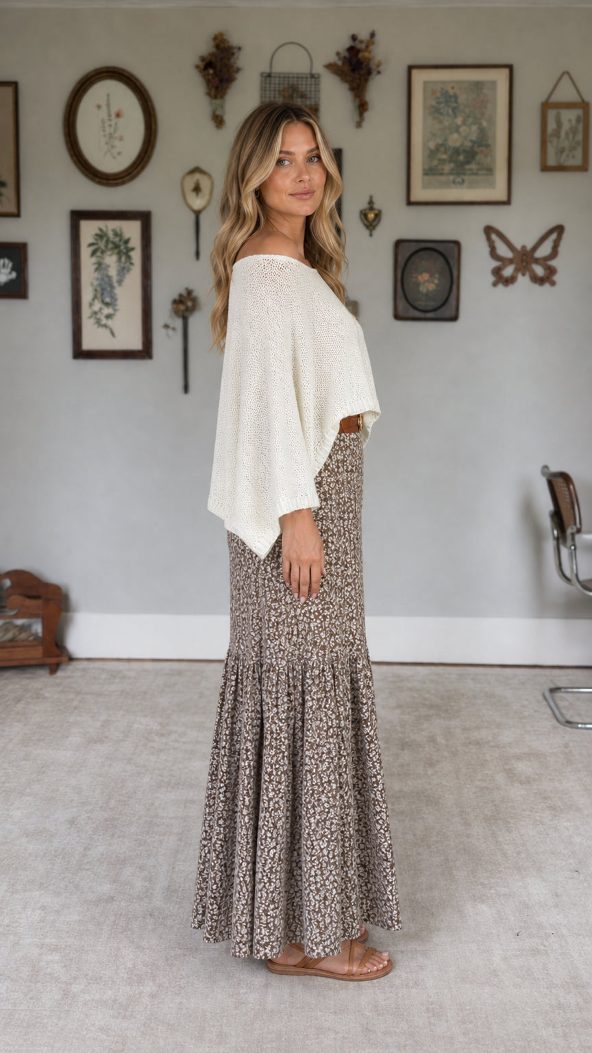 Model wearing white knit top and floral maxi skirt set, side view
