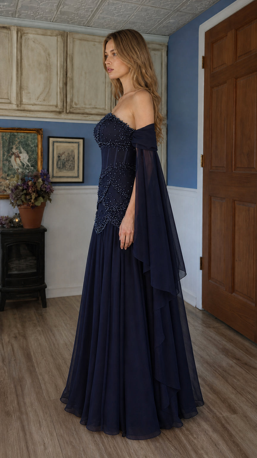 Side profile of navy blue evening gown with draped sleeves