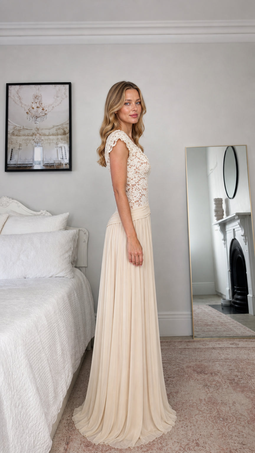 Side profile view of champagne long pleated evening gown