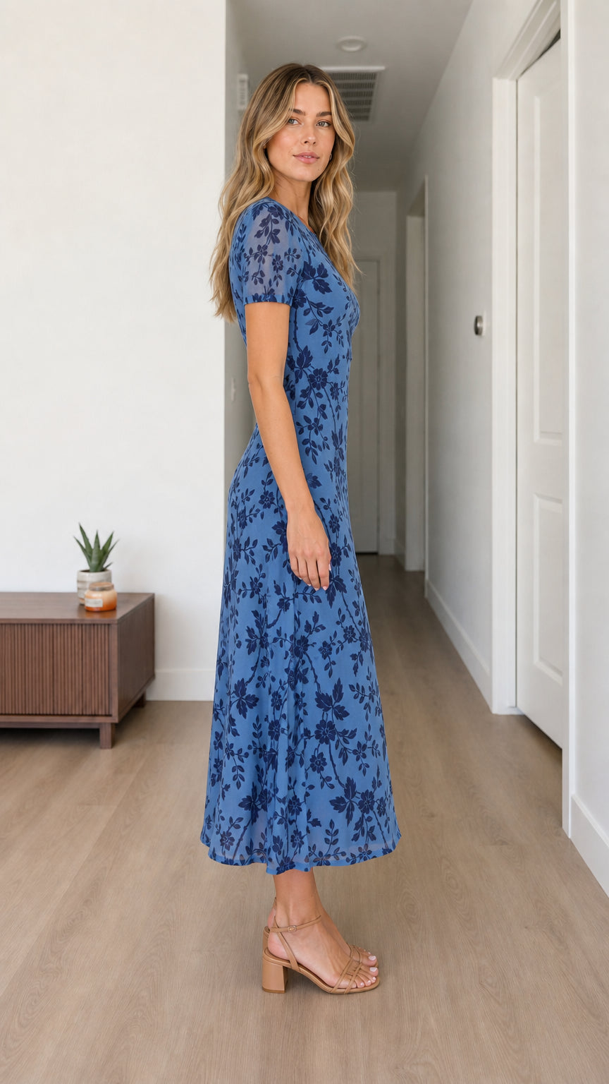 Side view of woman wearing blue floral midi dress