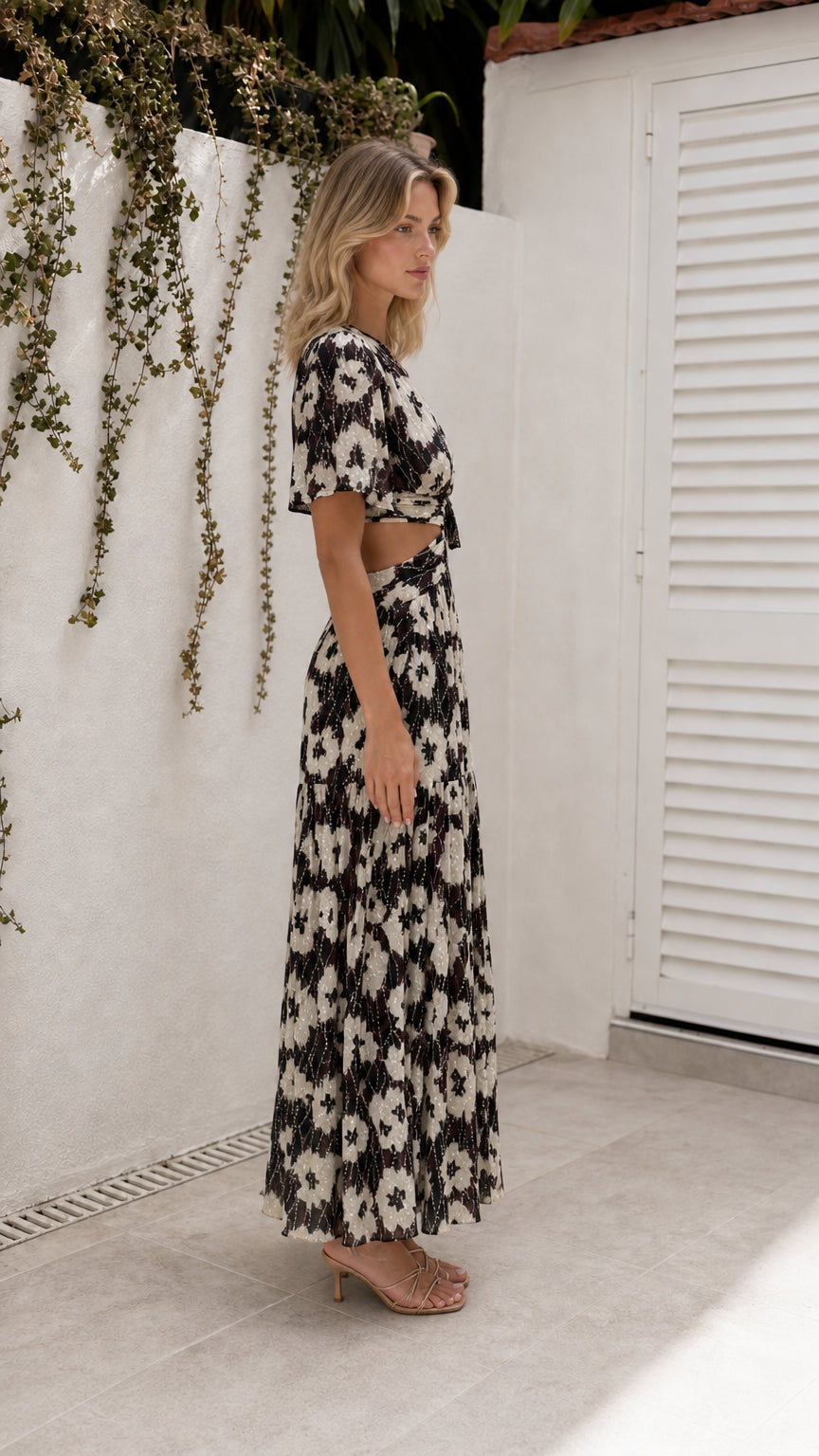 Side view of model wearing black floral cutout maxi dress