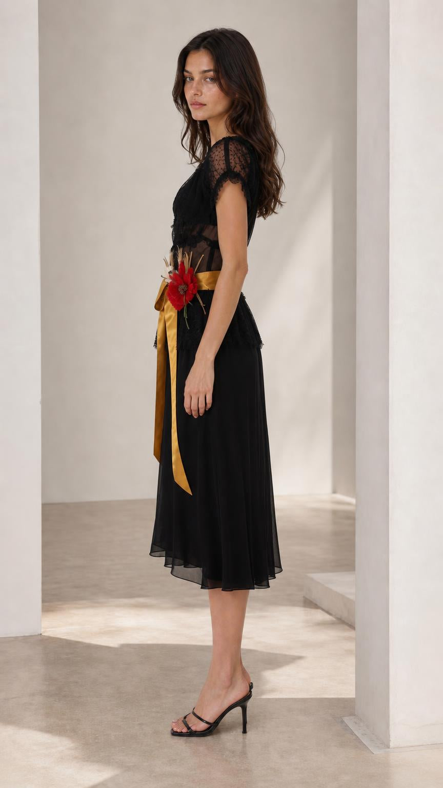 Side profile view of black midi dress