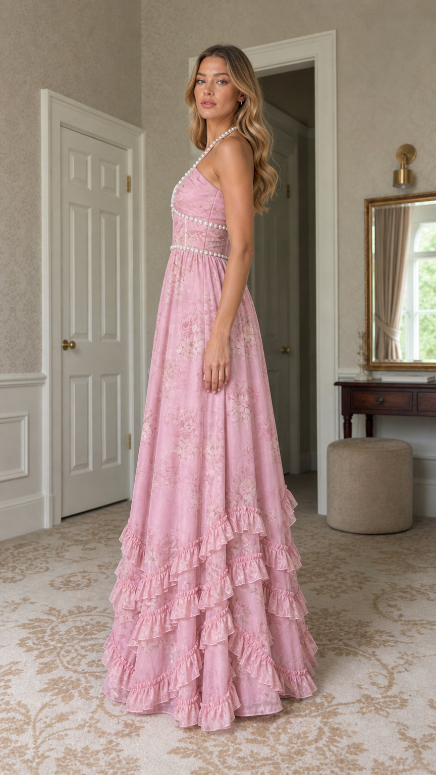 Side profile of model in pink floral halter maxi dress