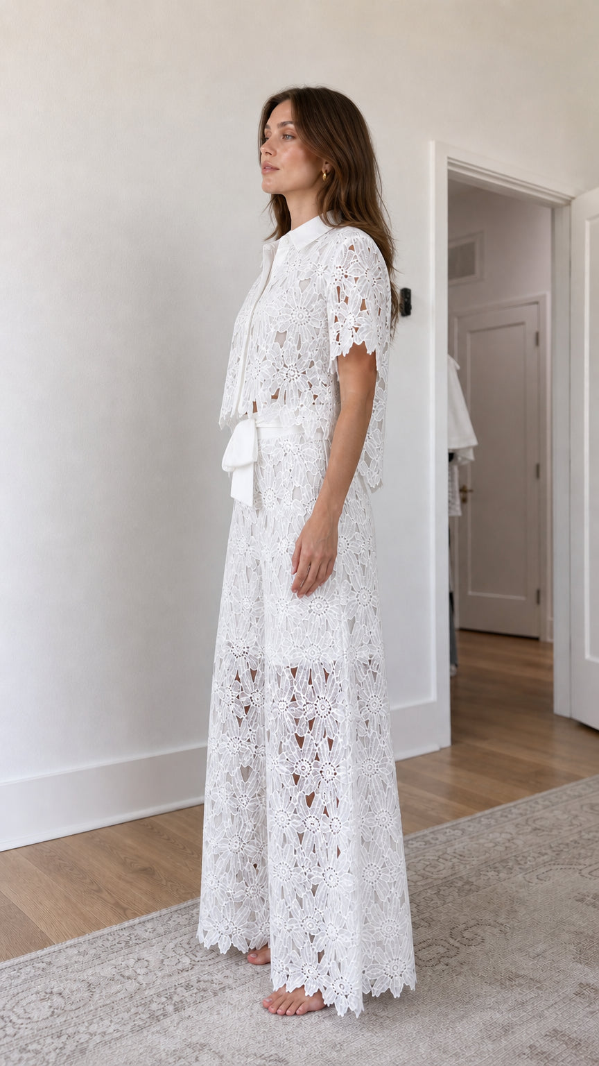 Side profile view of woman in white lace two-piece outfit