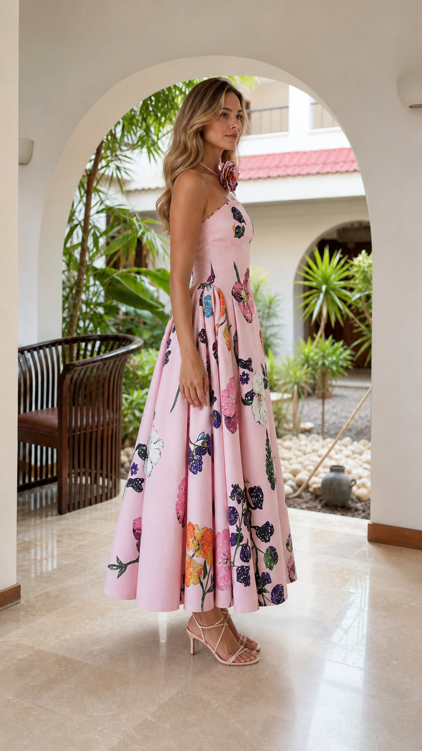 Side profile of model in pink floral strapless midi dress